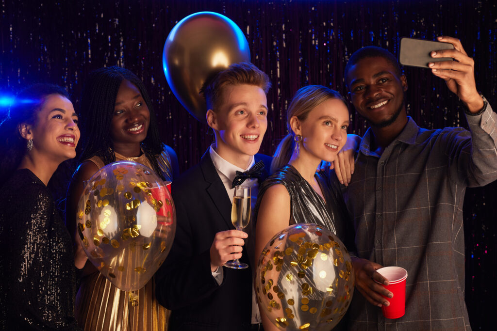 Elegant school formal venue with a beautifully decorated ballroom, vibrant lighting, and a dance floor filled with students celebrating.